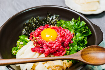 Yukhoebibimbap, Korean style Beef Tartare Bibimbap : This is a bowl of rice topped with seasonal namul (seasoned vegetables) and fresh yukhoe (chopped raw beef) and served with seasoning. Lean fresh r