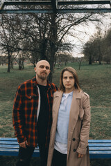 Portrait of a young white couple looking at the camera with suspicion.