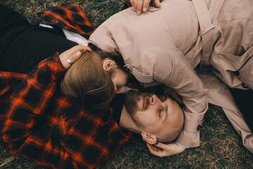 young couple laying on grass. summer love