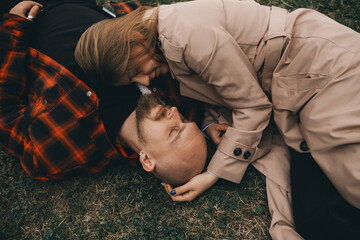 young couple laying on grass. summer love