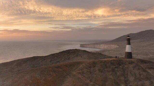 Magical sunset in a bright lighthouse, the cliffs with sea birds. Puerto Eten at sunset, Lambayeque, Peru