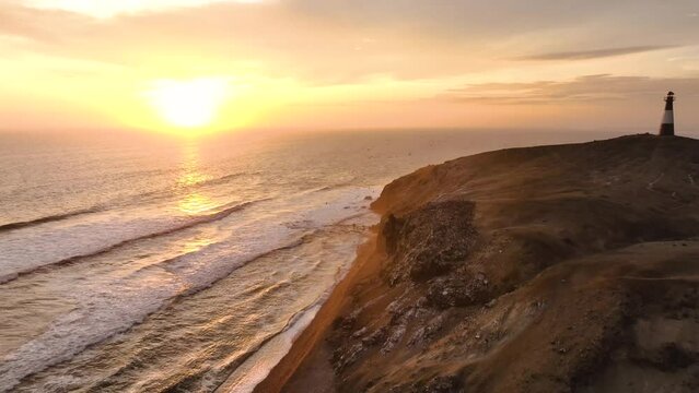 Magical sunset in a lighthouse, the cliffs with sea birds. Puerto Eten at sunset, Lambayeque, Peru