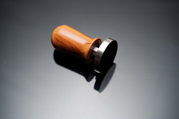 A wooden handle coffee tamper for tamping coffee