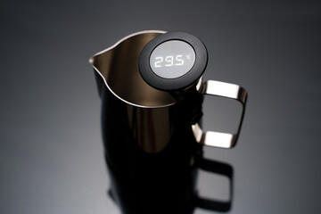 A 350ml metal frothing pitcher with digital temperature guage