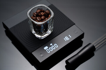 Coffee bean inside the espresso glass scale shot on a digital coffee scale preparing for coffee brewing