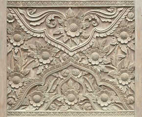 Pattern of flower carved on wood background.