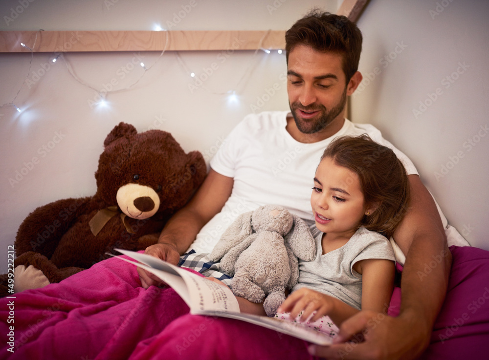 Poster She cant sleep without Dad first reading her a story. Cropped shot of a father reading a book with his little daughter in bed at home.