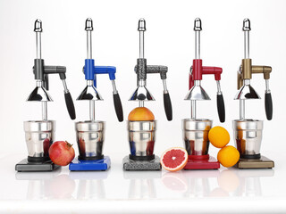 Juice maker, orange squeezers in different colors and oranges