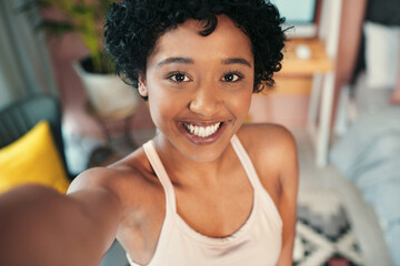 Its a new day and Im feeling good. Portrait shot of a young woman taking selfies at home.