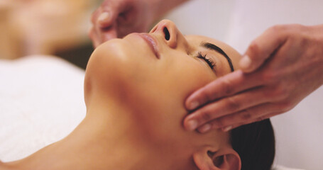 My mind is finally at ease. Shot of a beautiful young woman enjoying a head massage at a beauty spa.