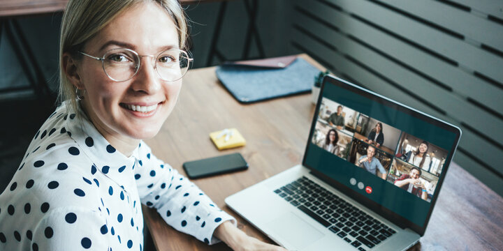 Portrait of woman. Video call conference with her remote team. Laptop with camera teamwork