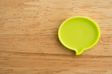 Chat bubbles on social media communication. Green chat bubbles icon messages on wooden background minimal style. Social media online, social network concept.