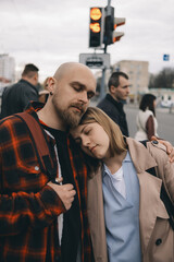 loving couple standing wearily in the arms of the city