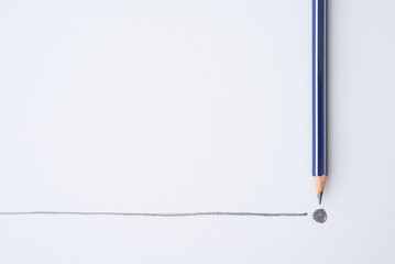 Flat lay of blue pencil write line and end point on white paper background copy space. Business...