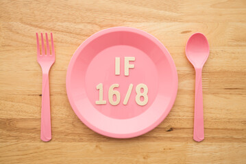 IF (Intermittent Fasting) 16 and 8 diet rule and weight loss concept. IF 16 and 8 letter on pink...
