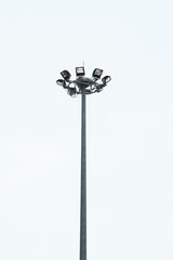 Electric poles and large spotlights provide light. on a white background