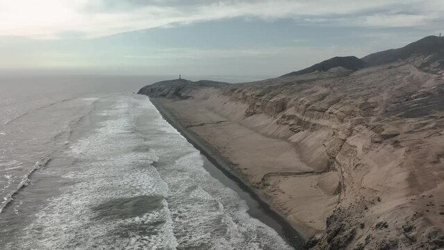 Aerial view of Media Luna Beach and lighthouse, Puerto Eten, Lambayeque, Peru.