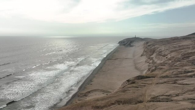 Aerial view of Media Luna Beach and lighthouse, Puerto Eten, Lambayeque, Peru.