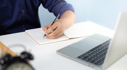 Corporate businessman working at office desk, his is working with a laptop and connecting with a digital touch screen tablet. Business objects of engineers office with construction engineer architect.