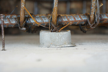 Closeup concrete cylindrical spacer mortar, used to support reinforcement not to stick to the formwork during concrete pouring.