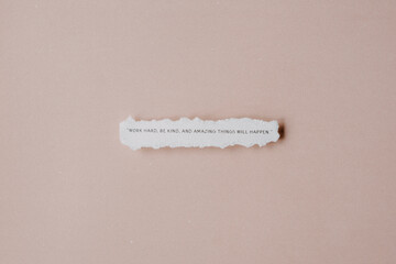A quote about motivation on a piece of scrap paper against a neutral background