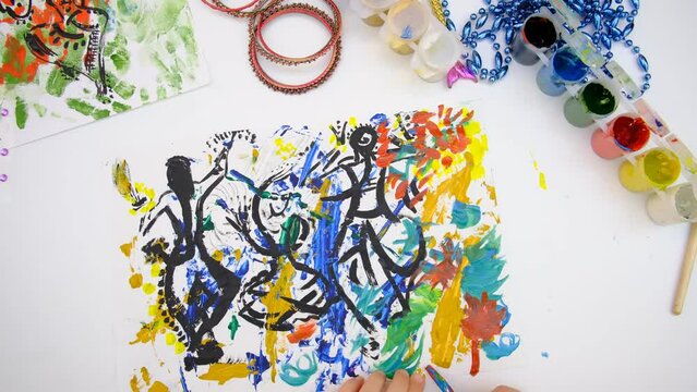 Child creativity. Painting with mixed media with abstract lines paints, abstract silhouettes dancing girls in an Indian costume, freehand lines 