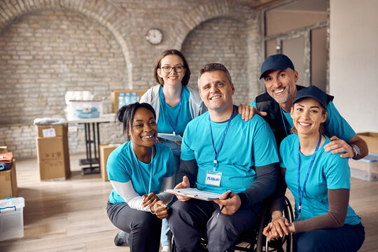 Portrait Of Happy Diverse Volunteers Working At Community Center And Looking At Camera.