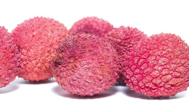 Pile of fresh ripe lychees on white background