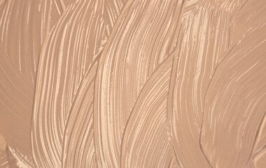 Foundation smeared as a swatch as a close-up background. Makeup cosmetics. Tone cream. Concealer texture.