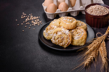 Homemade glazed puff pastry cinnamon rolls with custard and raisins
