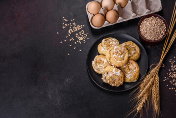 Homemade glazed puff pastry cinnamon rolls with custard and raisins