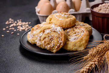Homemade glazed puff pastry cinnamon rolls with custard and raisins