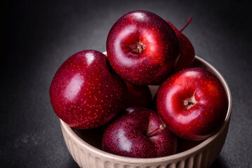 Delicious fresh apples in red on a dark concrete background