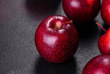 Delicious fresh apples in red on a dark concrete background