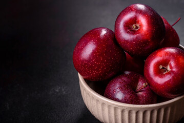 Delicious fresh apples in red on a dark concrete background