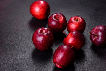 Delicious fresh apples in red on a dark concrete background