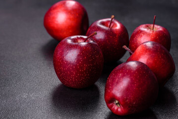 Delicious fresh apples in red on a dark concrete background