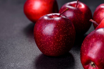 Delicious fresh apples in red on a dark concrete background