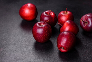 Fototapeta na wymiar Delicious fresh apples in red on a dark concrete background
