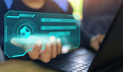Young businessman working on his laptop in the home office and holding the virtual screen to lockin for data security and cyber protection, internet network data.