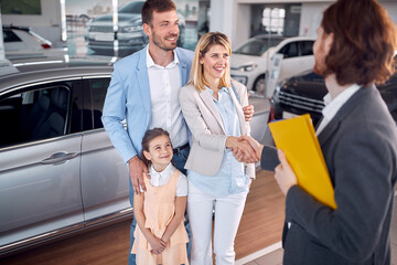 Fototapeta premium Saler congratultes family on buying new car