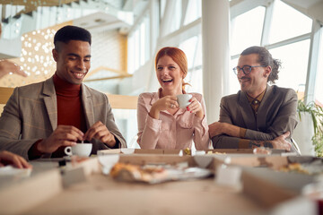 A young cheerful business woman and her male colleagues are in a very good mood during a lunch break in the company building. Business, people, company - obrazy, fototapety, plakaty