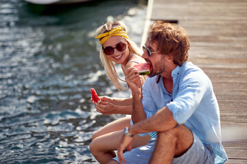 Smiling  man and woman enjoying together at holiday .and eating watermalon