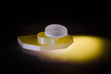 Glass objects lying on a black surface painted in different colors. A multicolored glass object. Prism