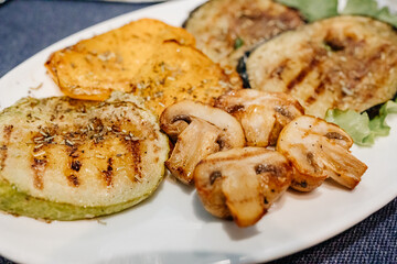 grilled mushrooms, eggplant, zucchini and bell peppers on a plate. 