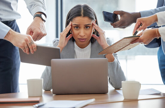 This is too much for me. Shot of a young businesswoman feeling stressed out in a demanding office environment at work.