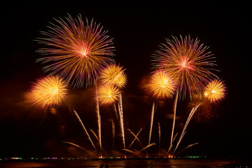 Color flashes of fireworks against the black sky.