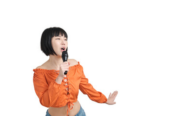 Young asian woman singing and dancing with microphone, isolated.