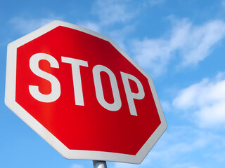 Stop sign with blue sky and clouds