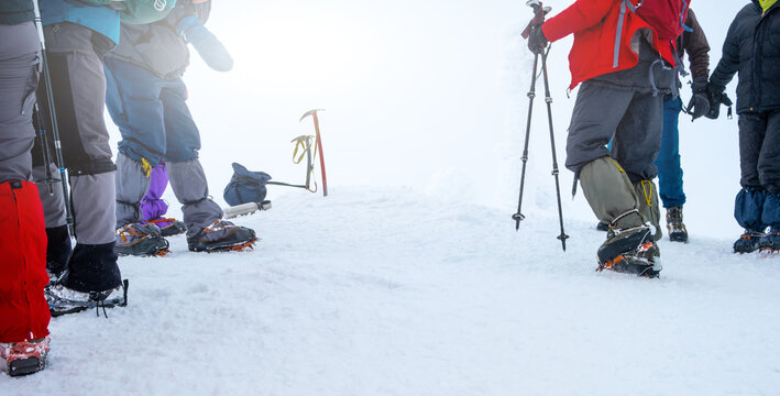 Group Of Tourists With Hiking Equipment For Winter Expedition